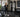 Commercial gym lunch-break workout zone with cardio machines, benches, free weights, and organized storage