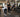 Premium commercial gym free weight area with organized dumbbells, benches, racks, barbells, and open training space