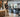 Compact residential community fitness center with cardio machines, strength equipment, dumbbells, and an open exercise area
