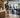 Compact residential community fitness center with cardio machines, strength equipment, dumbbells, and an open exercise area