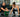 Athletes performing Olympic lifts with proper coaching and equipment in a modern gym setting