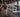 Organized commercial gym strength area with squat racks, lifting platforms, weight plates, and clear member walkways