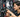 Close-up of a gym power rack with J-hooks and spotter arms set up for barbell safety inspection