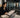 Heavy free weight training area in a 24-hour gym with dumbbells, plates, racks, and durable flooring