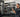 Organized gym rack area with attachment storage solutions for cable handles and accessories
