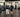 Gym owner reviewing a strength equipment layout organized by muscle group on a clean commercial training floor