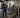 Gym facility manager inspecting an aging commercial exercise machine for wear and maintenance issues