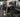 Organized commercial gym free weight area with dumbbells, benches, racks, and strength training equipment