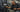 Gym member using a selectorized weight stack machine with a reminder to lower the stack gently