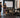 Residential gym with simple strength equipment, organized storage, and open training space